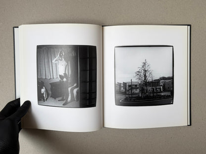 Open spread of Walk while ye have the light by Yoshiichi Hara, showing two black-and-white photographs on white pages.