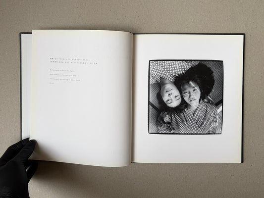 Open spread of Walk while ye have the light by Yoshiichi Hara, with a title page on the left and a black-and-white photograph of two faces on the right.