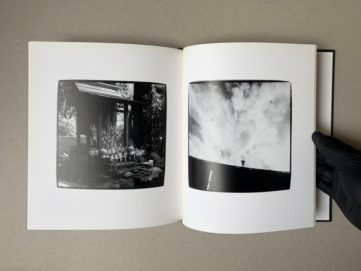 Open photobook spread from Walk while ye have the light by Yoshiichi Hara, showing two black-and-white photographs on white pages.