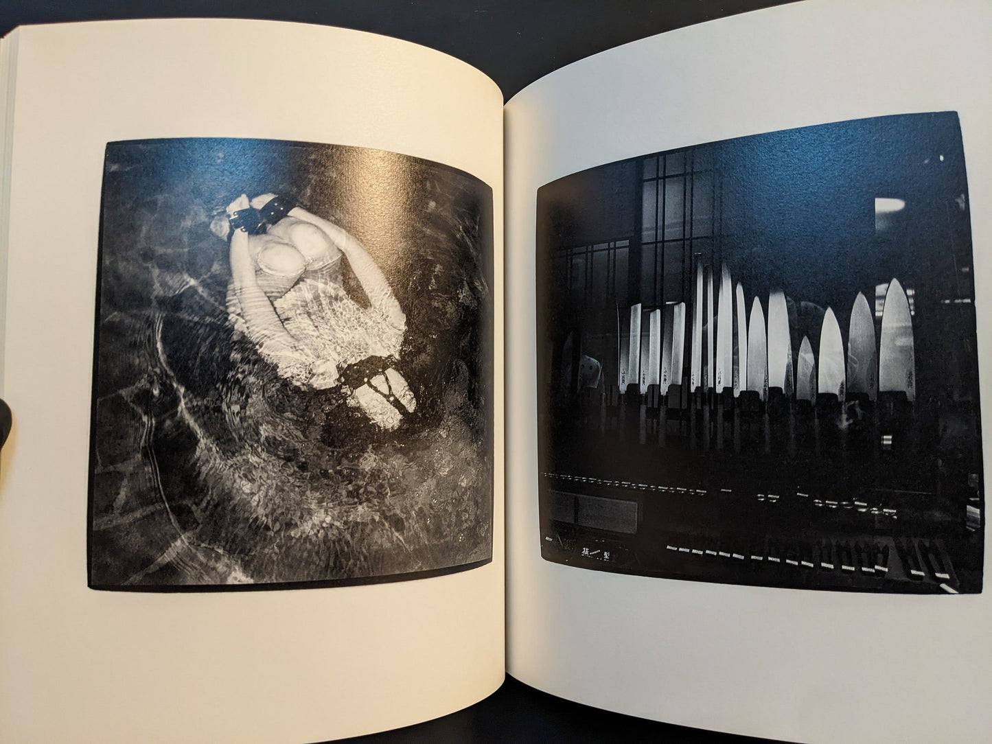 Spread with a figure floating in rippling water above and a dark shop interior below.