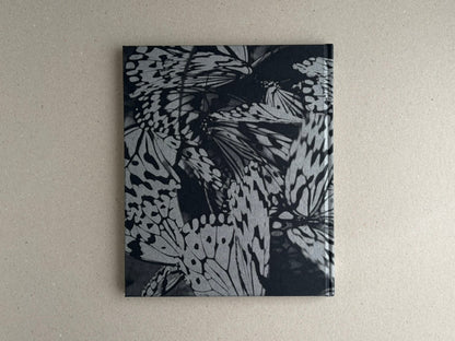 Wandering Dog by Mai Nakama, back cover of a black-and-white photobook with overlapping butterfly wings on the cover