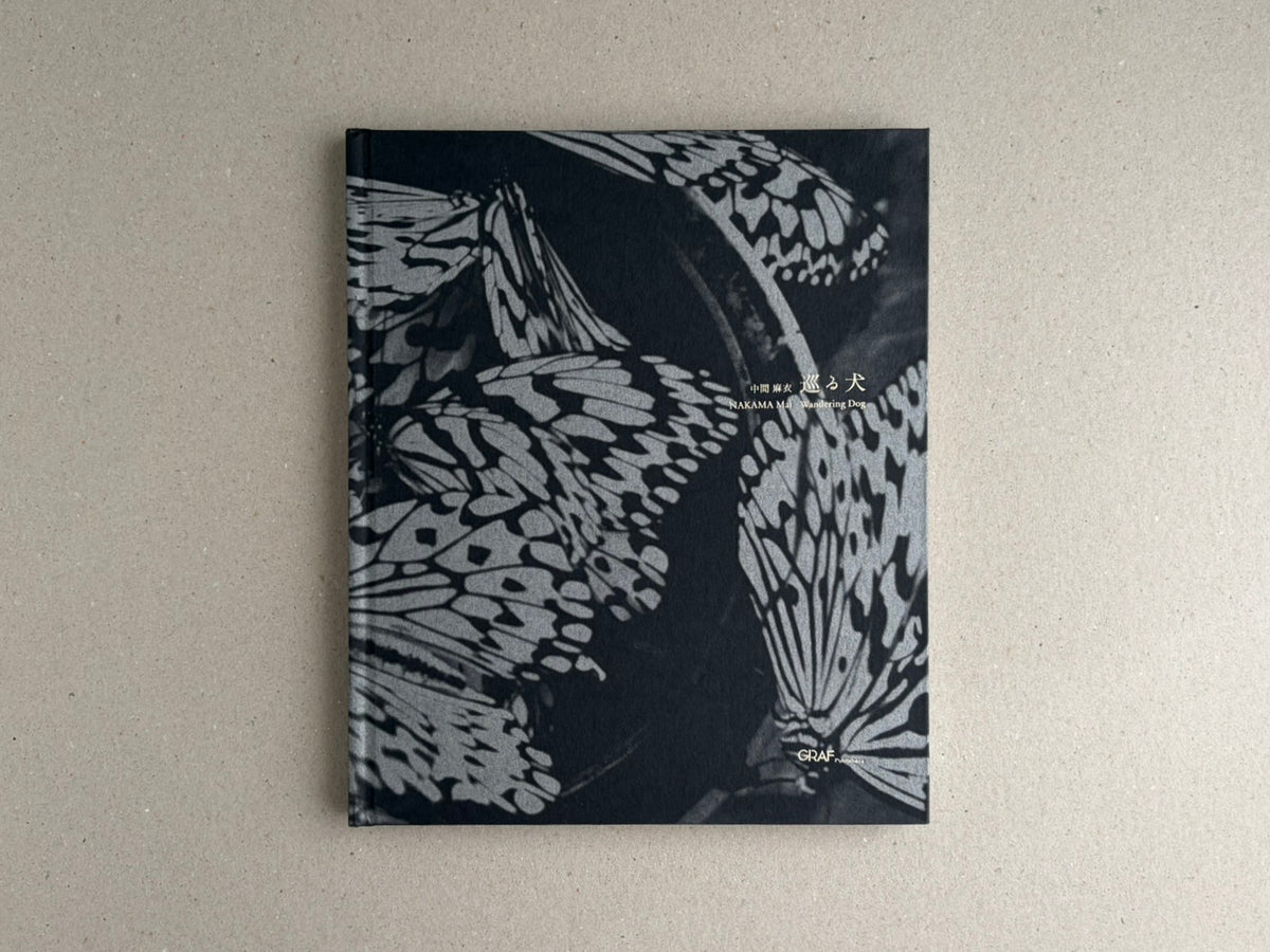 Front cover of Wandering Dog by Mai Nakama, with black-and-white butterfly wings and the GRAF logo.