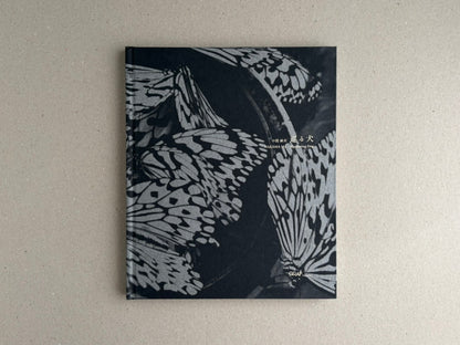Front cover of Wandering Dog by Mai Nakama, with black-and-white butterfly wings and the GRAF logo.