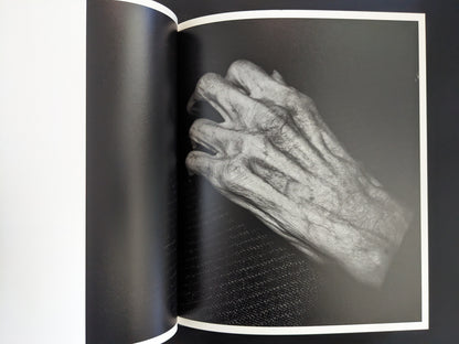 Black and white close-up photograph of an old wrinkled hand from Mai Nakama’s photobook Wandering Dog.