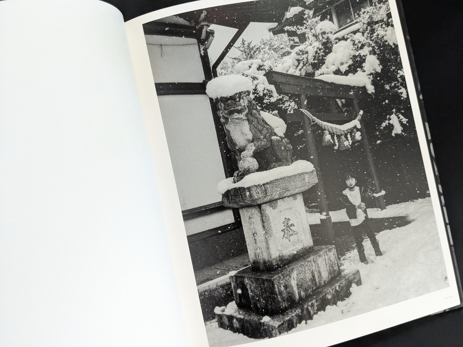 Snow-covered shrine with child in winter from Wandering Dog by Mai Nakama