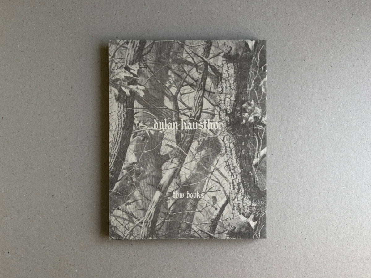 Front cover of What the Rain Might Bring by Dylan Hausthor, showing a black-and-white forest image with the title and TBW Books imprint.