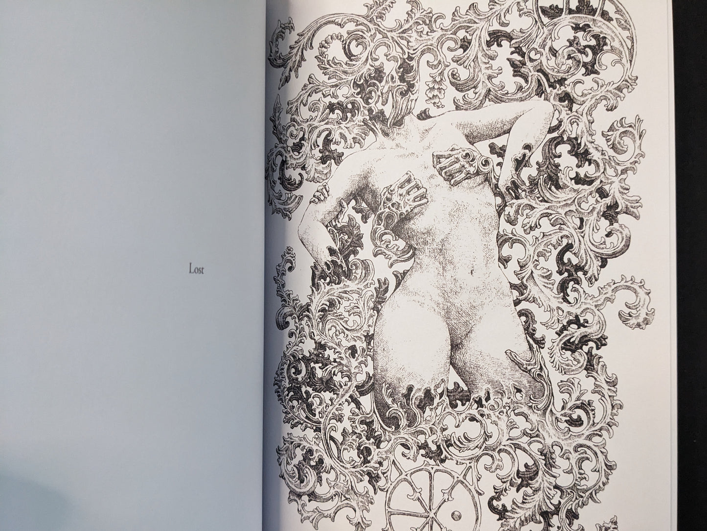 “Lost” spread from Where Shadows Breathe: The Art of Melf by Melf, black-and-white figure framed by baroque ornamental patterns.