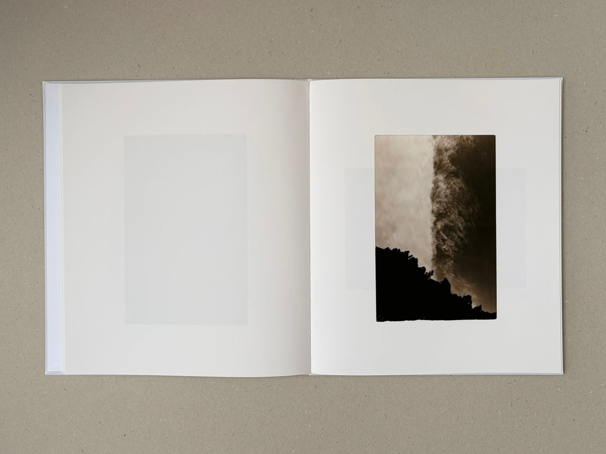 Open Yamamoto Masao photobook showing a two-page spread with a small vertical image on the right page and a blank image area on the left.