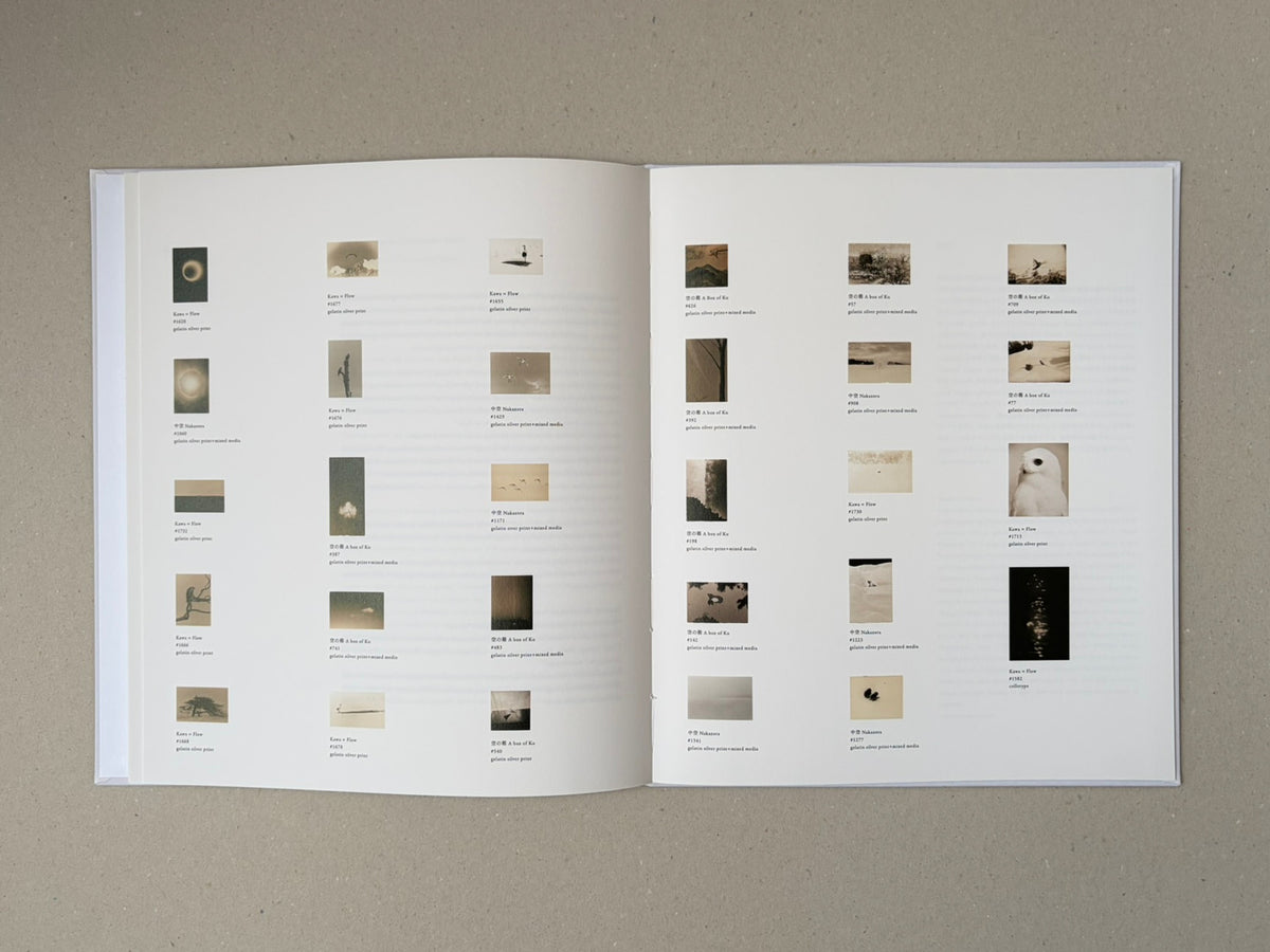 Open spread of Yamamoto Masao showing a grid of small reproduced photographs with captions on both pages.