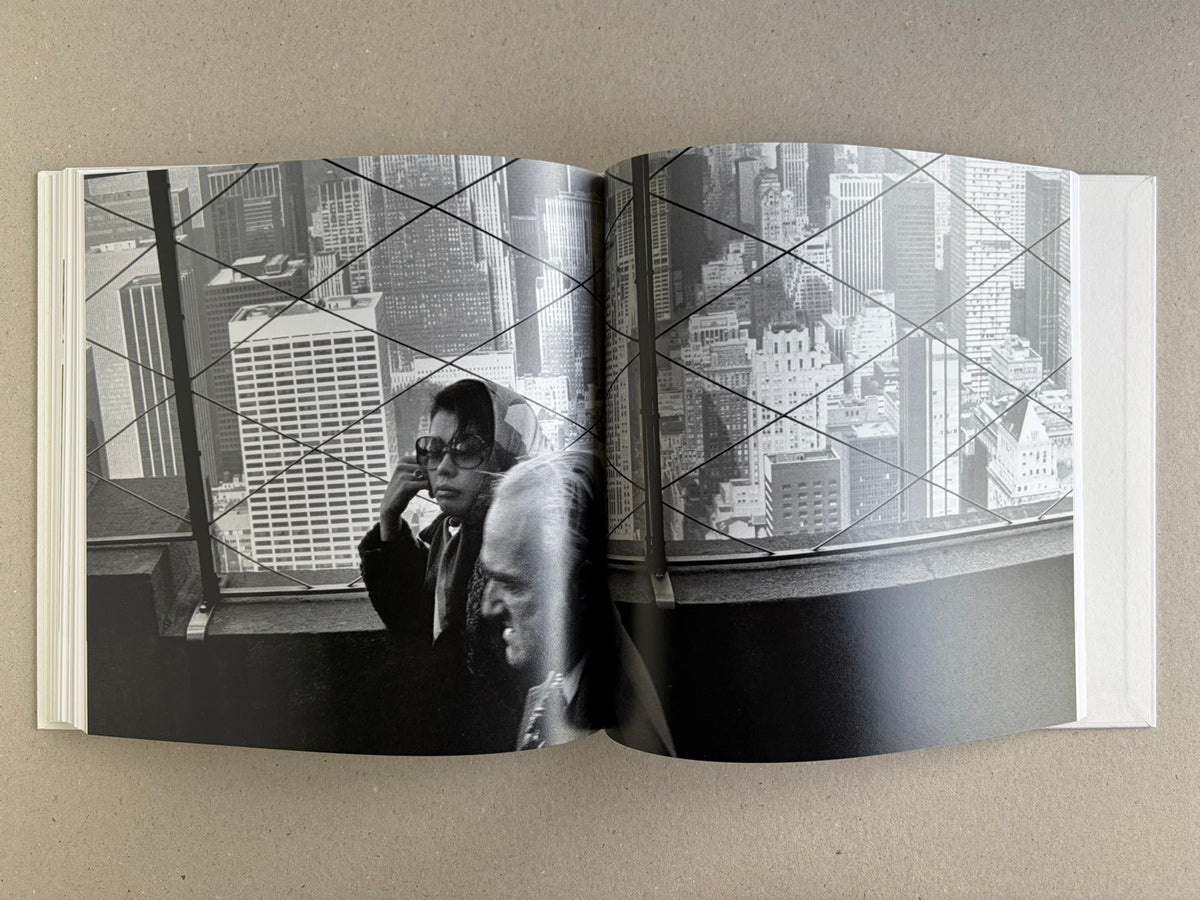 Yoko – Masahisa Fukase, spread with a city view and figures behind a window grid.