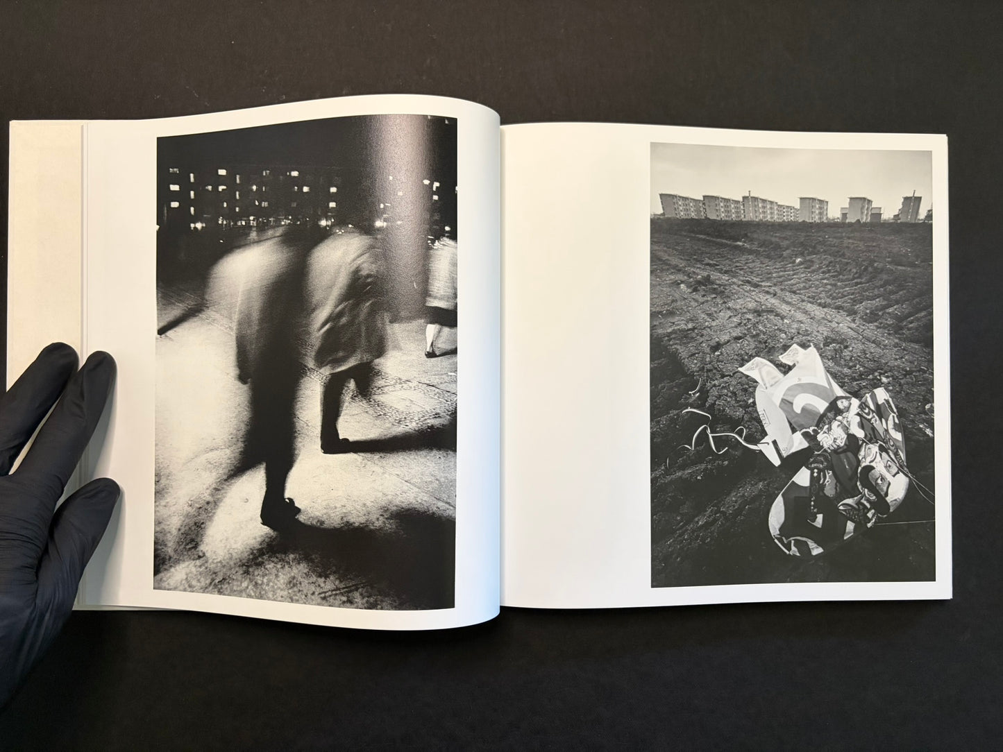 Open spread with a woman standing in a street on the left and a dark city scene on the right.