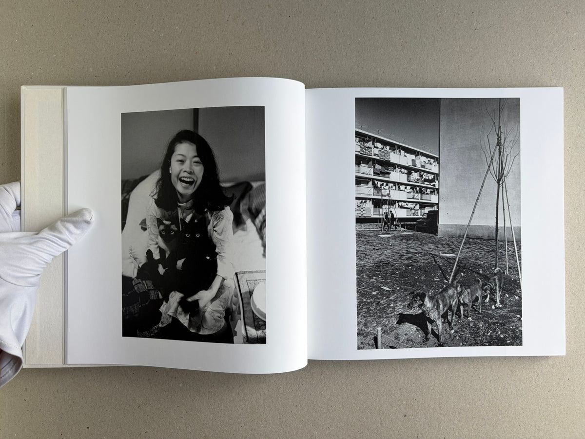 Yoko – Masahisa Fukase, two-page spread with a portrait of Yoko Miyoshi on the left and a building scene with dogs on the right.