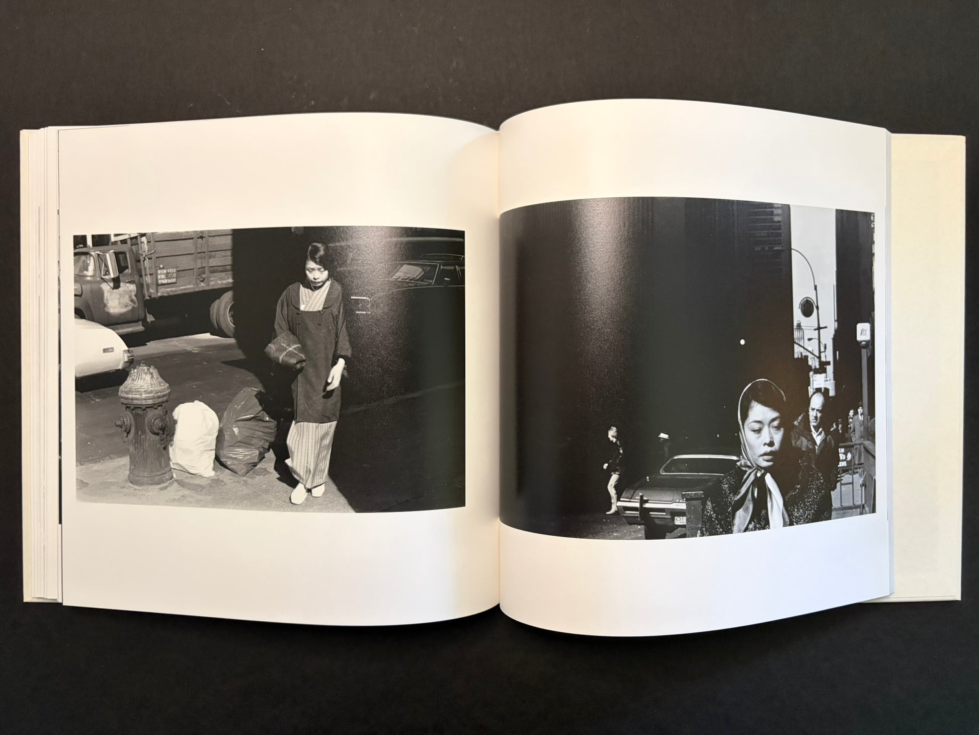 Open spread with a woman in a narrow street on the left and a close portrait in the dark on the right.