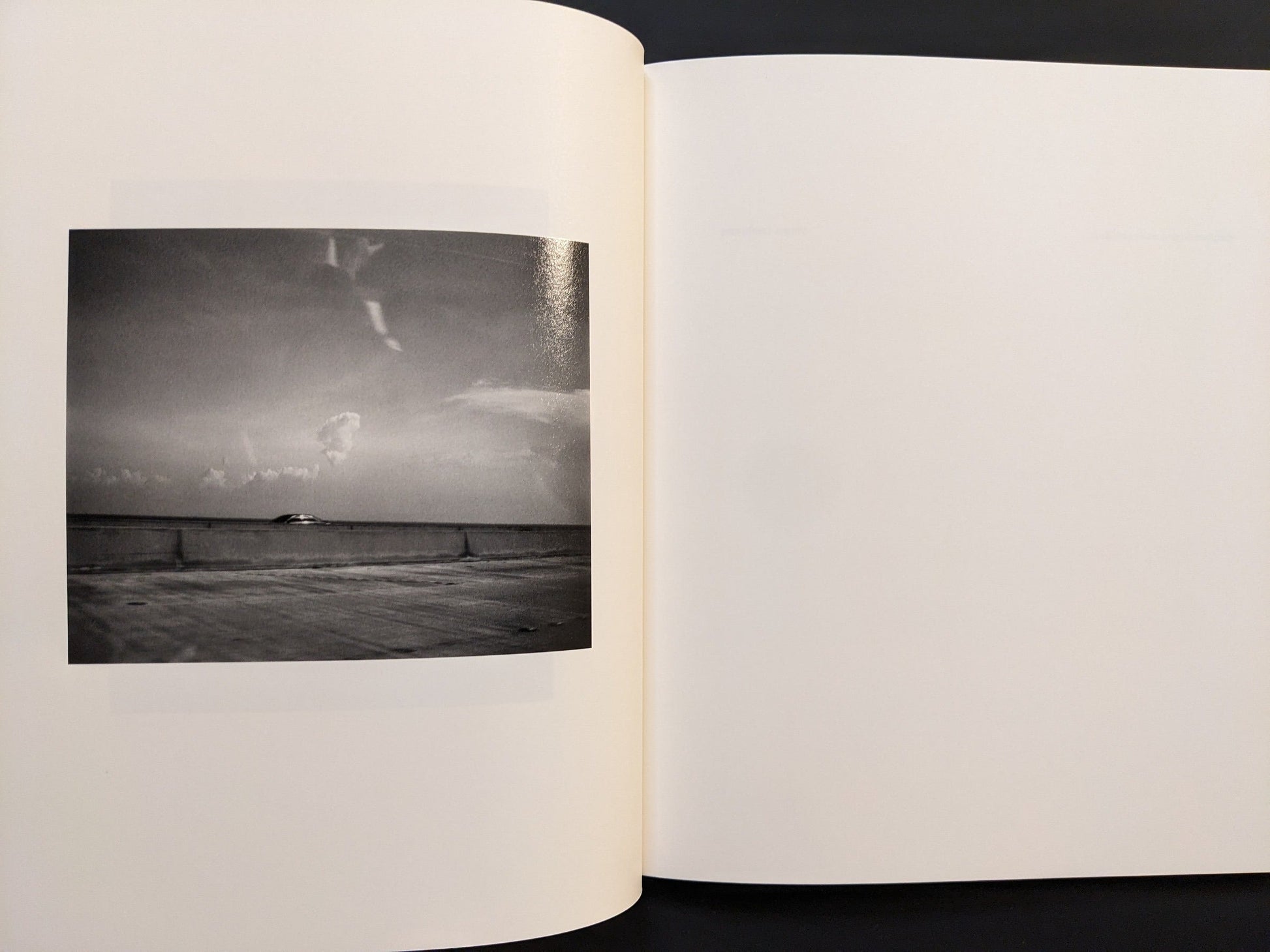 Page view featuring a minimalist black-and-white photograph from i shall sing these songs beautifully by Yorgos Lanthimos.
