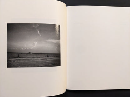 Page view featuring a minimalist black-and-white photograph from i shall sing these songs beautifully by Yorgos Lanthimos.
