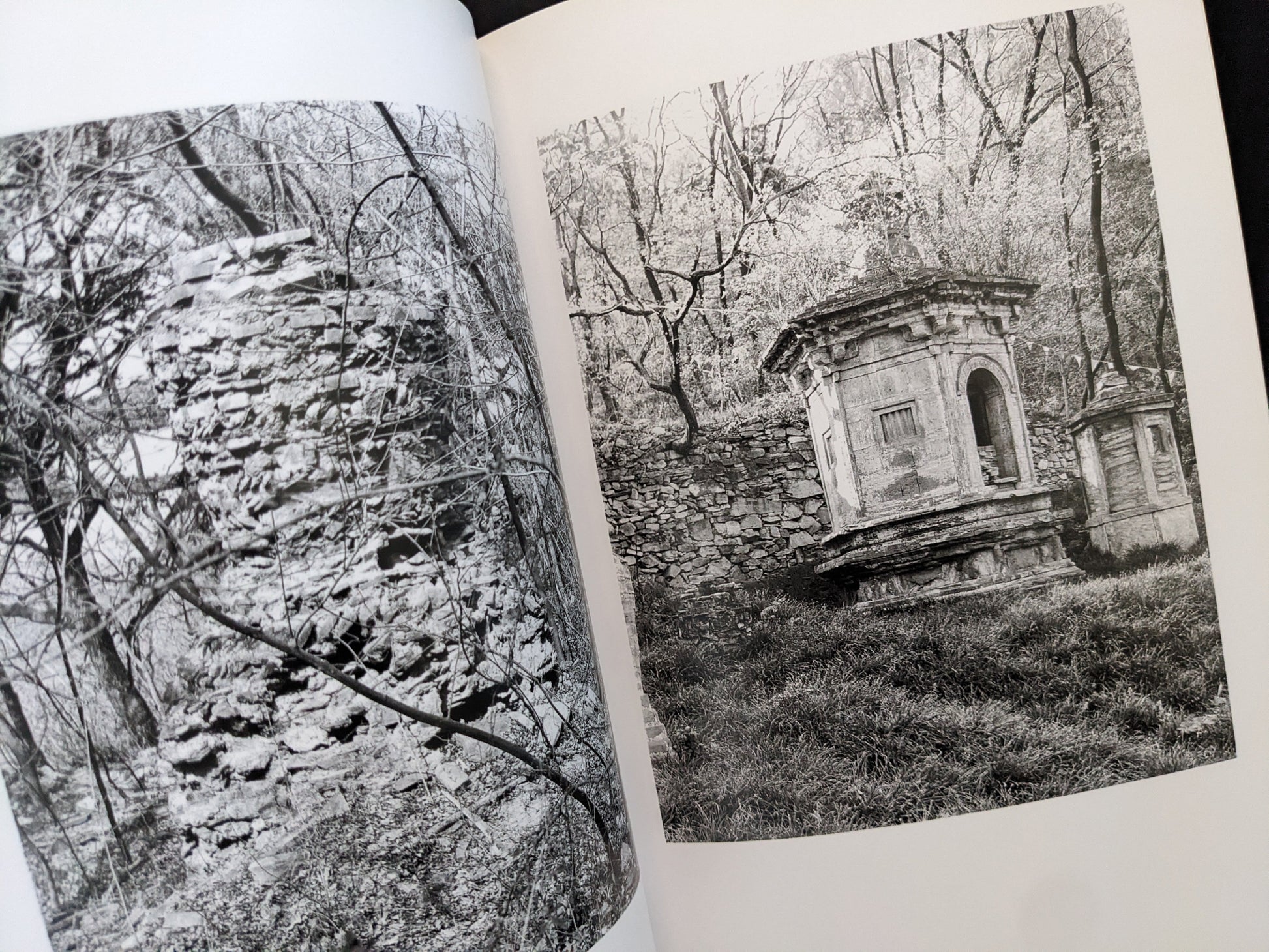 Pages from The Ancient Towers photobook with images of stone pagodas among trees.
