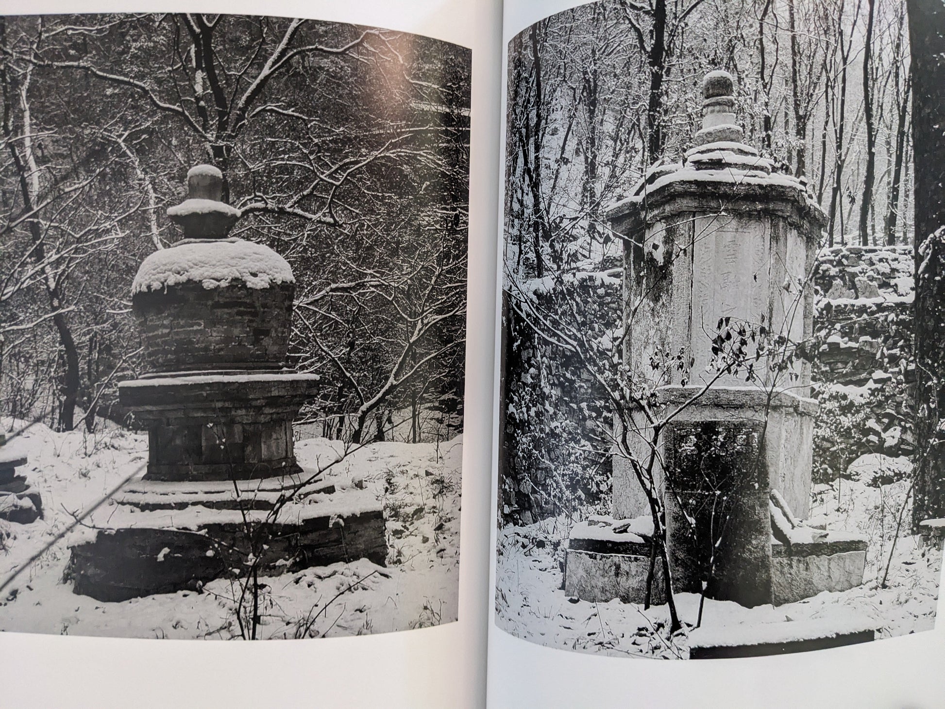 Spread from The Ancient Towers featuring images of stone towers partially covered in snow.